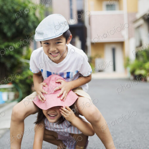 Family home. Two children, a boy and girl playing outdoors.