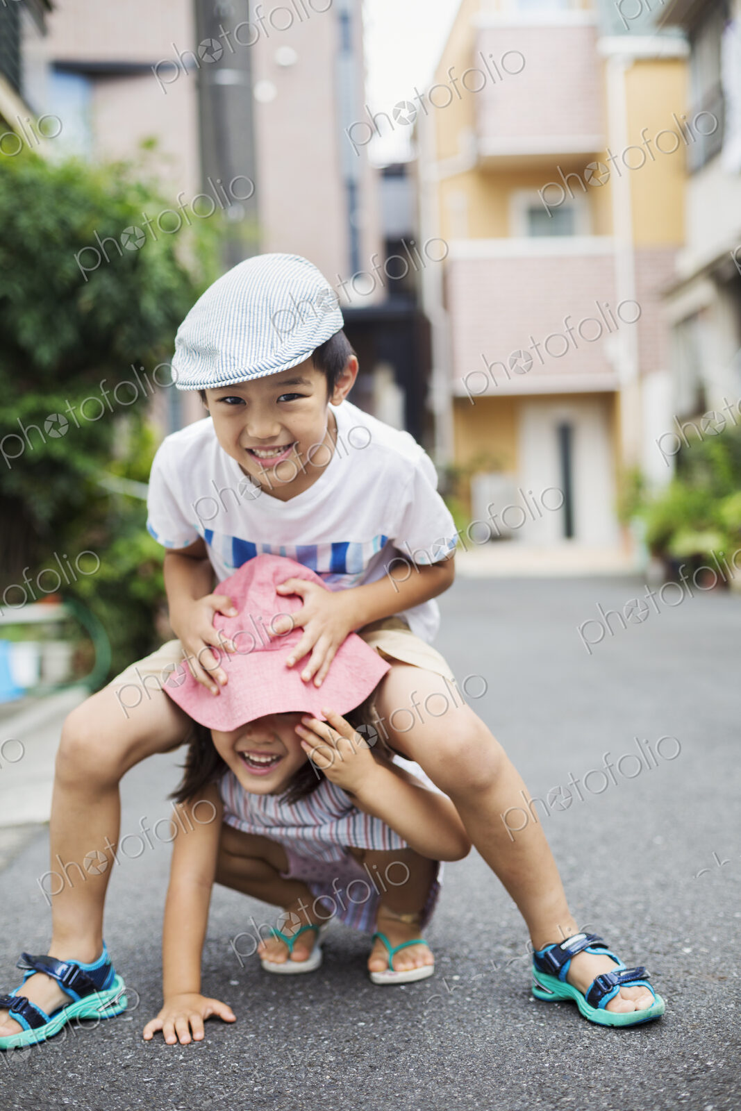 Family home. Two children, a boy and girl playing outdoors.