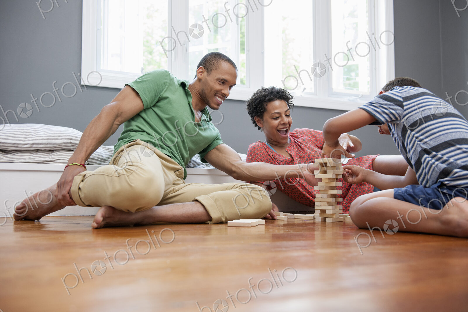 Family on the floor playing a game at home.