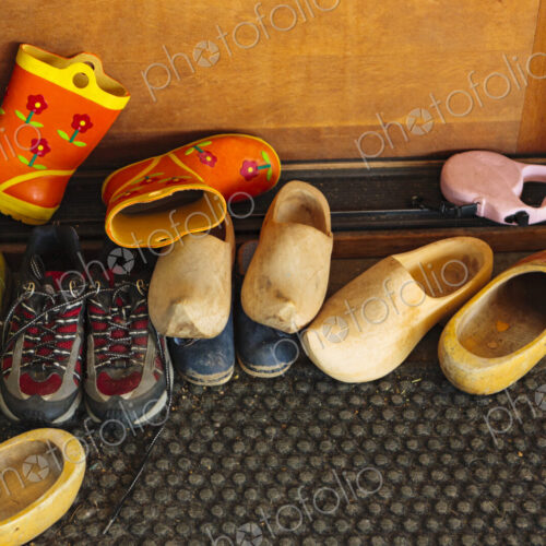 Family's shoes on door mat at entry way, WA, USA