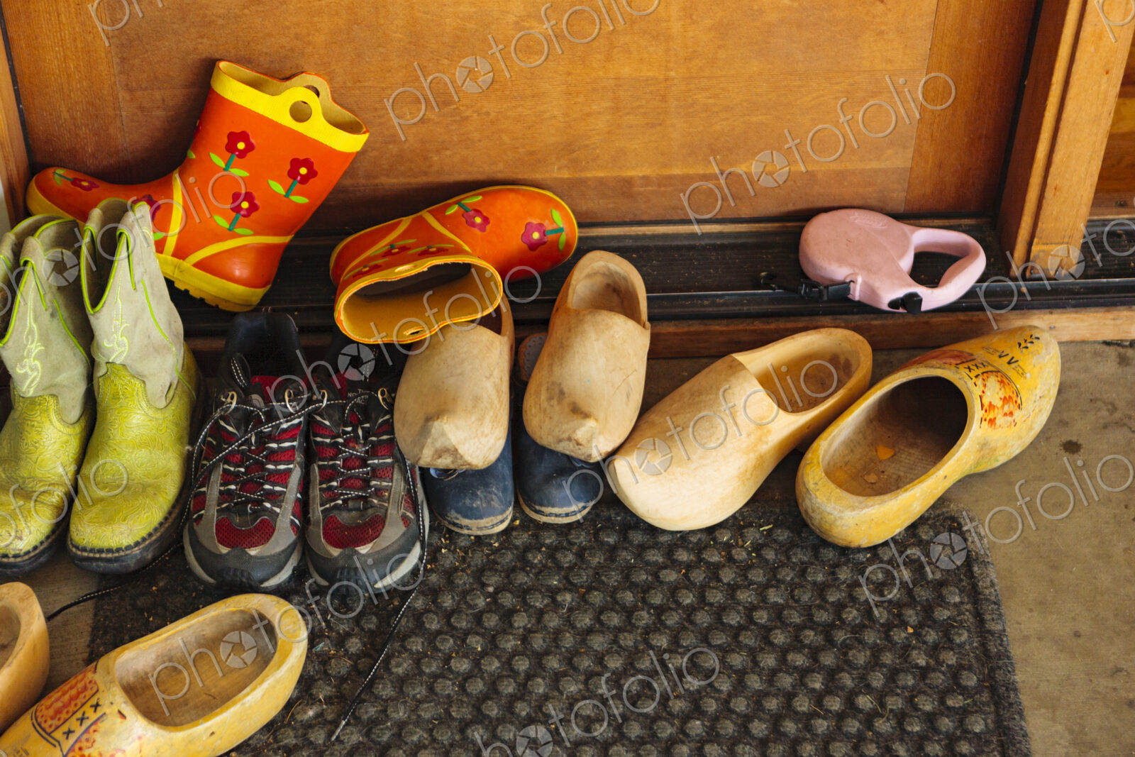 Family’s shoes on door mat at entry way, WA, USA