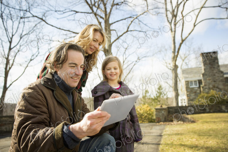 Farming family, man holding a digital tablet