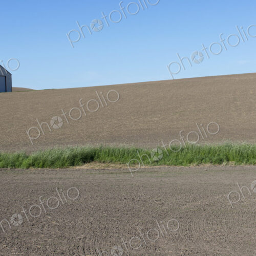 Farmland and barn in fallow field Farmland and barn in fallow field