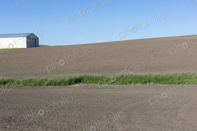 Farmland and barn in fallow field