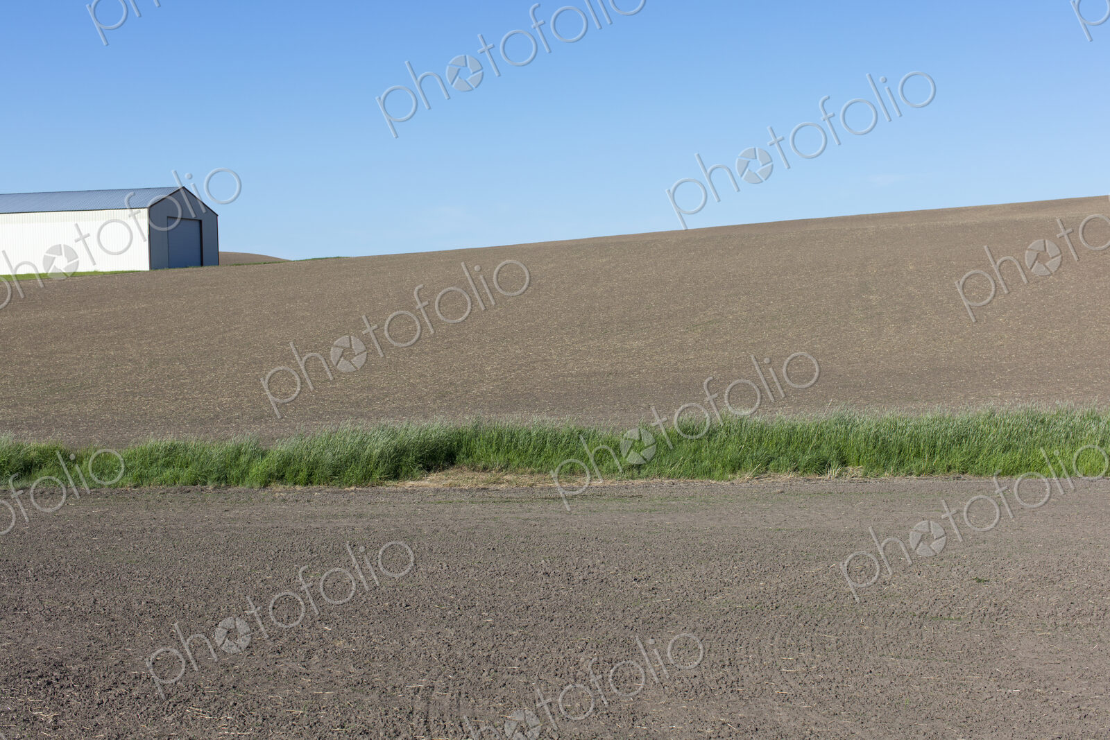 Farmland and barn in fallow field