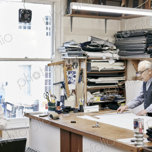 Father and son making suits in family-run tailor business Father and son making suits in family-run tailor business