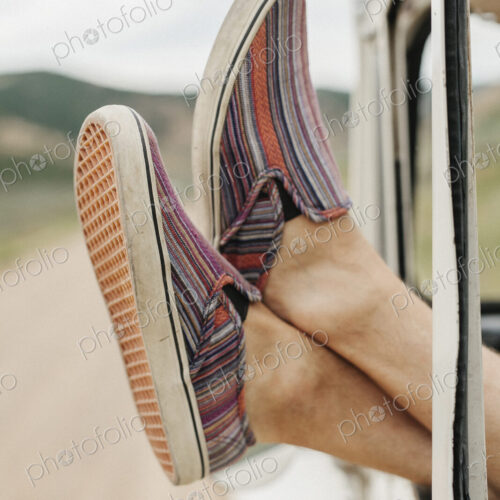 Feet of a man sticking out of a jeep window Feet of a man sticking out of a jeep window