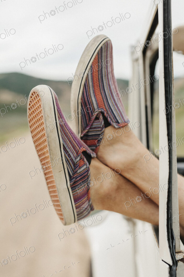 Feet of a man sticking out of a jeep window