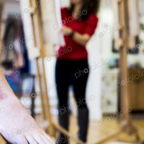 Female foot with red varnished toenails, a model at a life drawing class