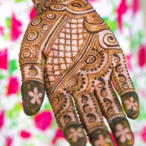 Female hand covered in Henna tattoos Female hand covered in Henna tattoos