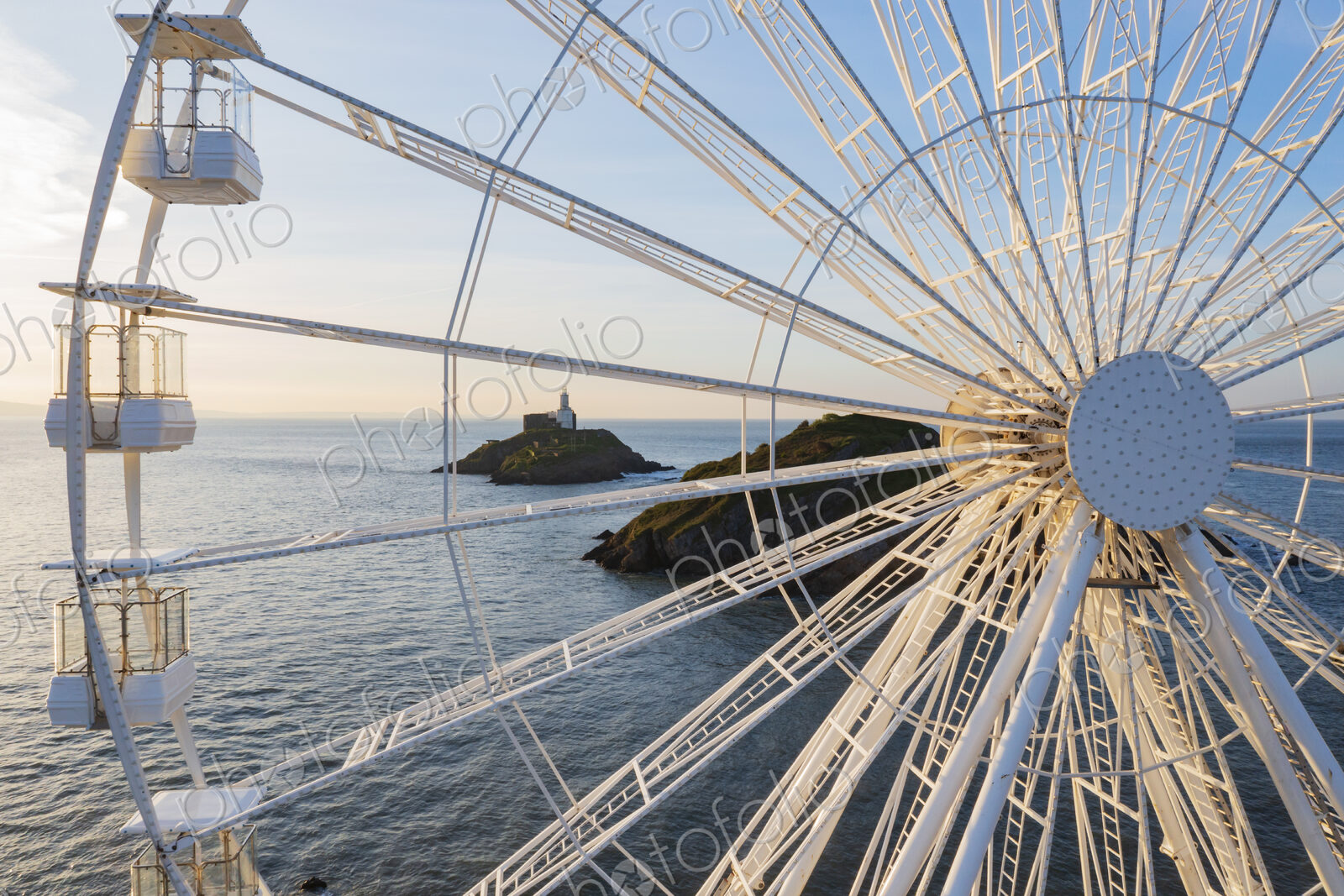 Ferris Wheel and the view through the framework to the Mumbles Lighthouse offshore