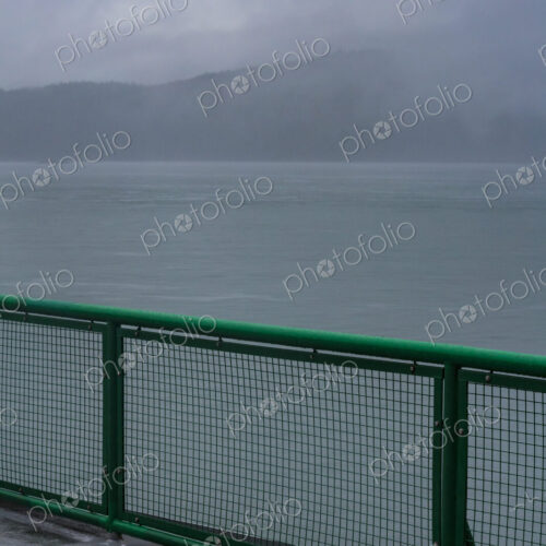 Ferry deck and railing on a boat sailing past the San Juan Islands Ferry deck and railing on a boat sailing past the San Juan Islands