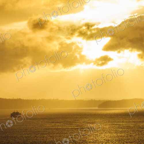 Ferry on ocean water under dramatic sky Ferry on ocean water under dramatic sky