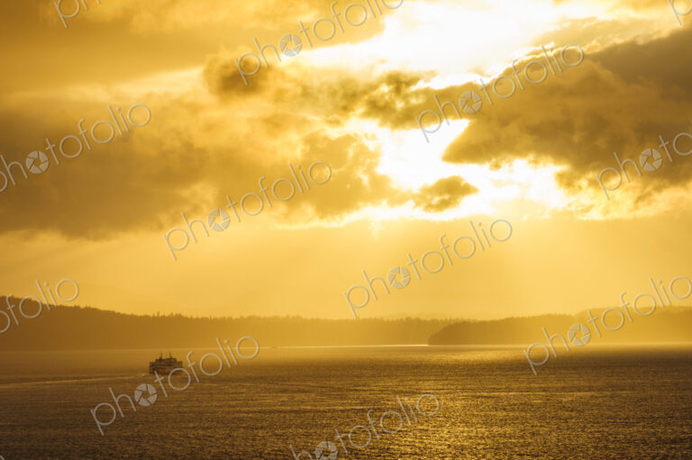 Ferry on ocean water under dramatic sky