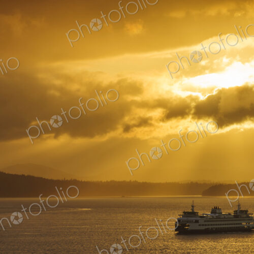 Ferry on ocean water under dramatic sky Ferry on ocean water under dramatic sky