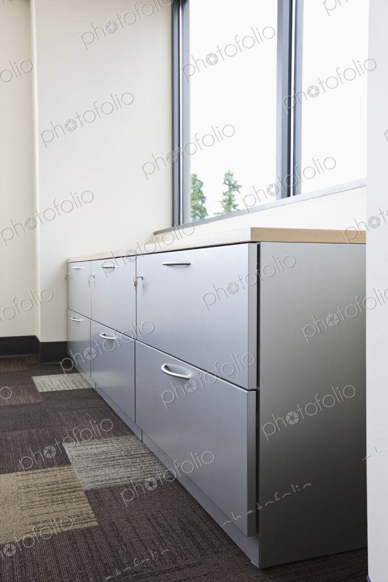 Filing cabinet and window in office.