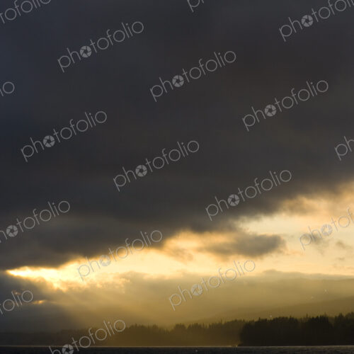 Filtered sun through dark clouds, Puget Sound, WA, USA Filtered sun through dark clouds, Puget Sound, WA, USA