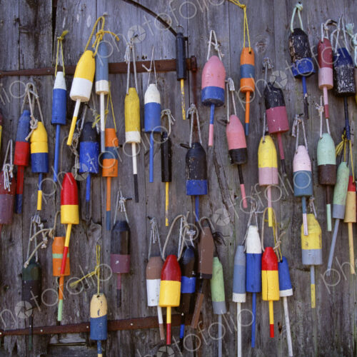 Fishing marker marine buoys or floats hanging on a fishing shed wall on the waterfront. Fishing marker marine buoys or floats hanging on a fishing shed wall on the waterfront.