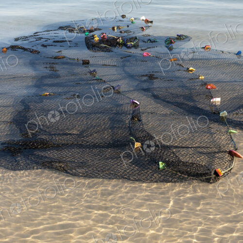 Fishing nets spread out in the shallow water by the shore. Fishing nets spread out in the shallow water by the shore.