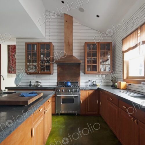 Fitted kitchen units, shelves,and sink by the window. A central island with smooth… Fitted kitchen units, shelves,and sink by the window. A central island with smooth…