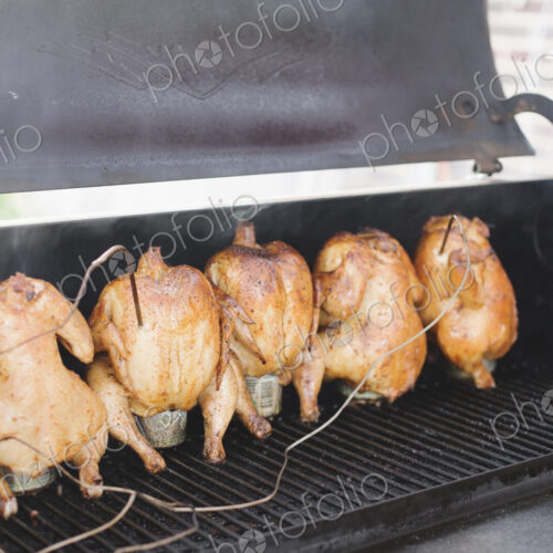 Five whole chickens roasting on a barbecue. Five whole chickens roasting on a barbecue.