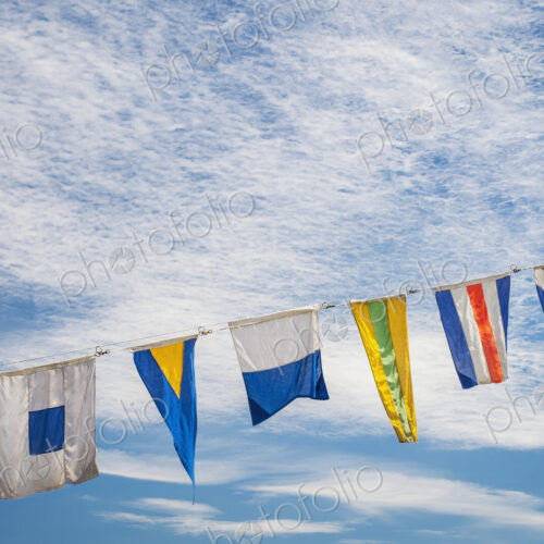 Flags flying against blue sky Flags flying against blue sky