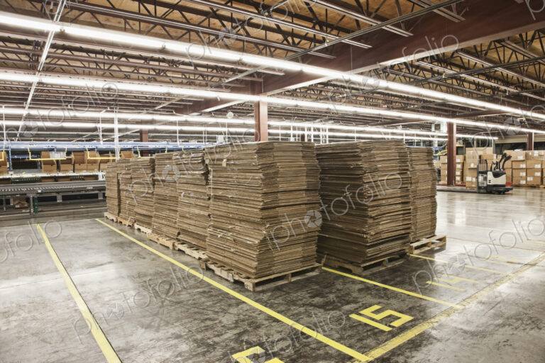 Flattened cardboard boxes in warehouse