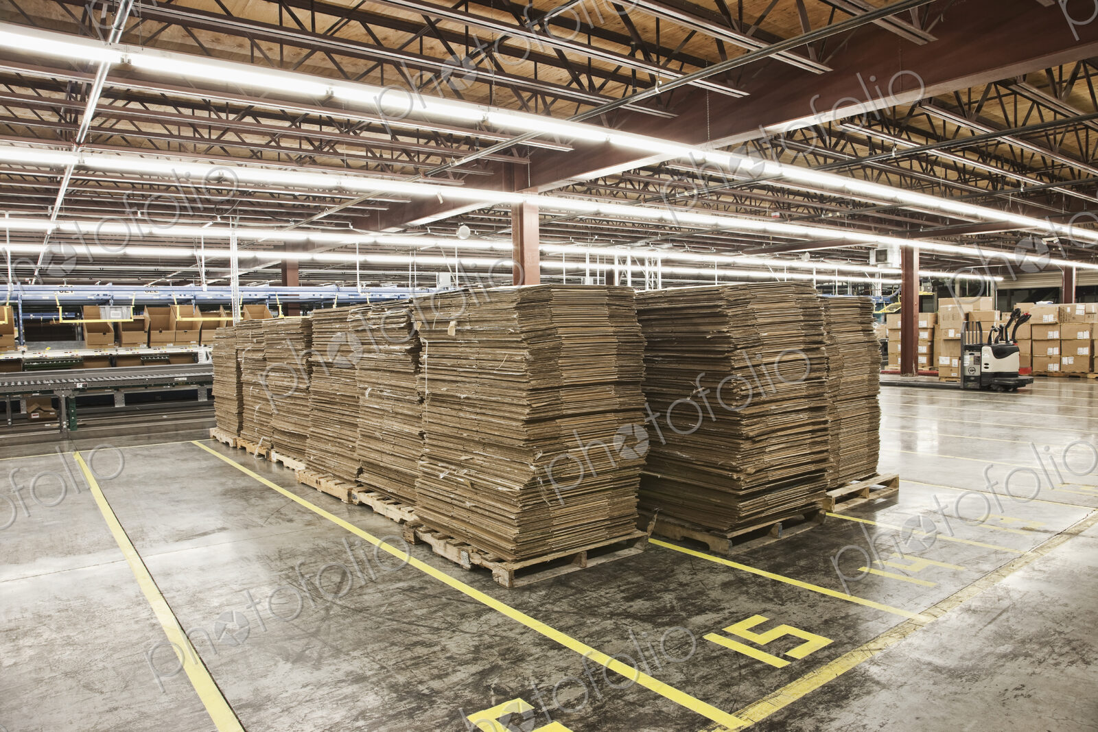 Flattened cardboard boxes in warehouse