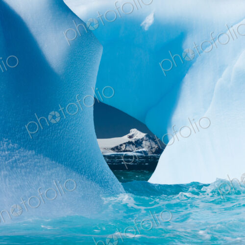 Floating icebergs framing a view of the ocean, Antarctica Floating icebergs framing a view of the ocean, Antarctica