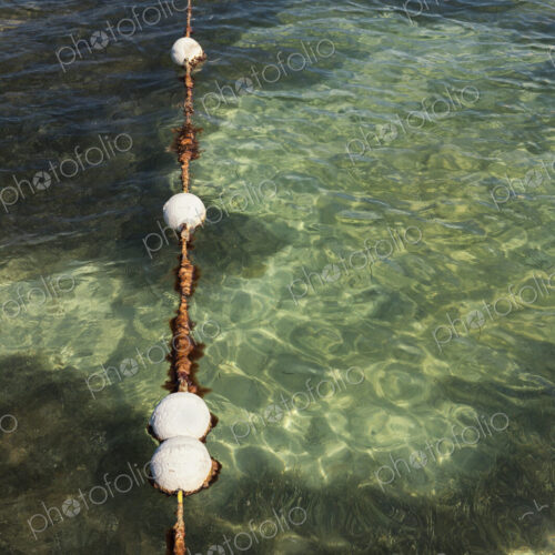 Floats in water marking the swimming area in the sea Floats in water marking the swimming area in the sea