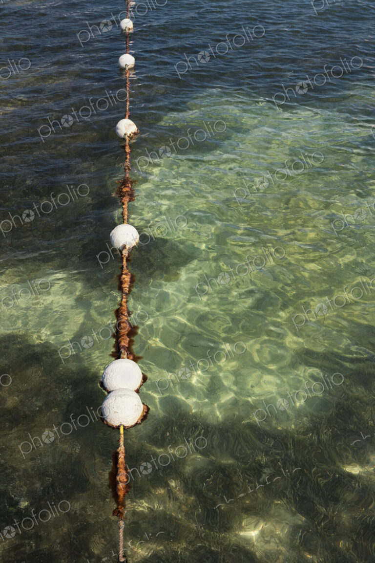 Floats in water marking the swimming area in the sea