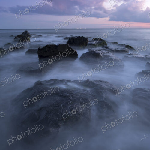 Fog on rocks at ocean Fog on rocks at ocean