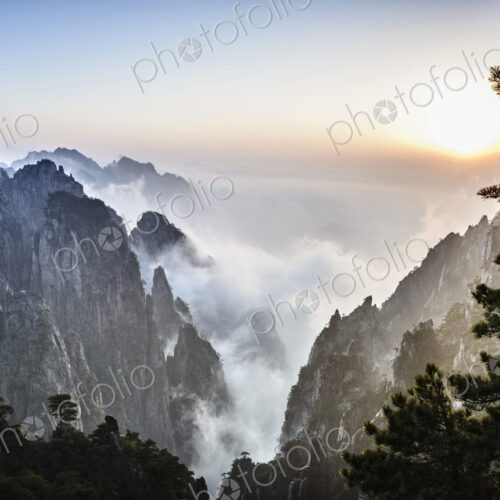 Fog rolling over rocky mountains, Huangshan, Anhui, China Fog rolling over rocky mountains, Huangshan, Anhui, China