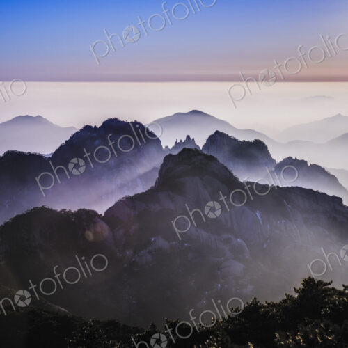 Fog rolling over rocky mountains, Huangshan, Anhui, China Fog rolling over rocky mountains, Huangshan, Anhui, China