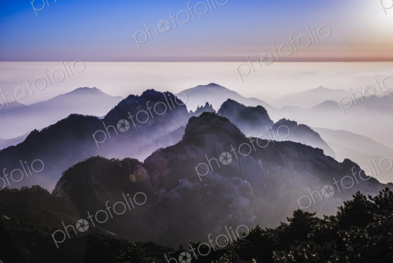 Fog rolling over rocky mountains, Huangshan, Anhui, China