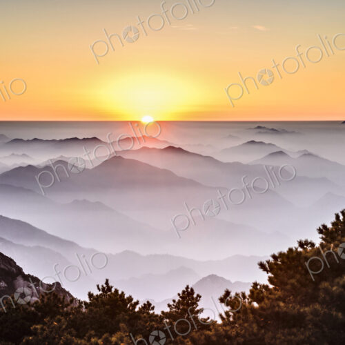 Fog rolling over rocky mountains, Huangshan, Anhui, China Fog rolling over rocky mountains, Huangshan, Anhui, China