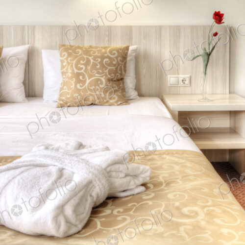 Folded robe on bed in hotel room