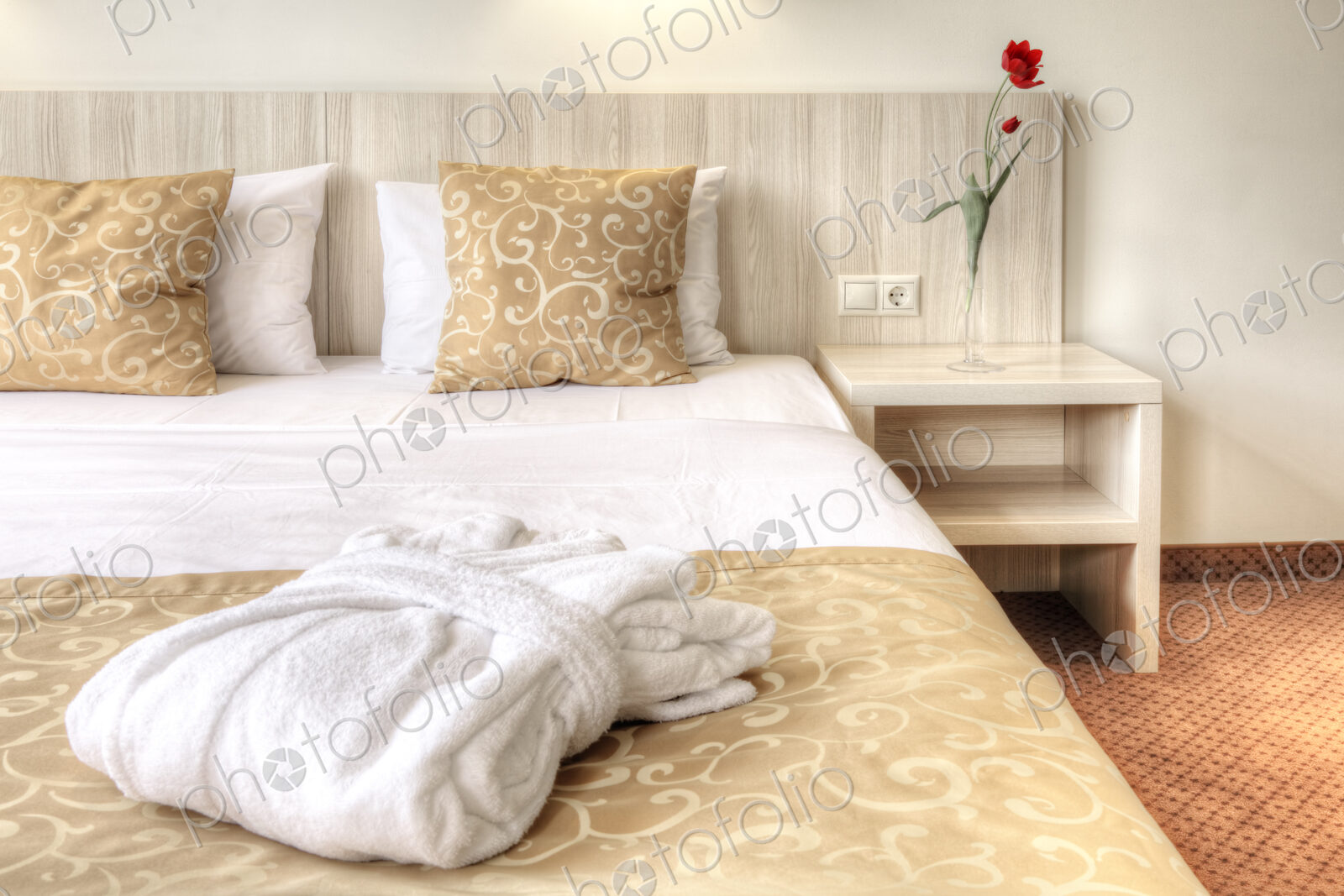 Folded robe on bed in hotel room