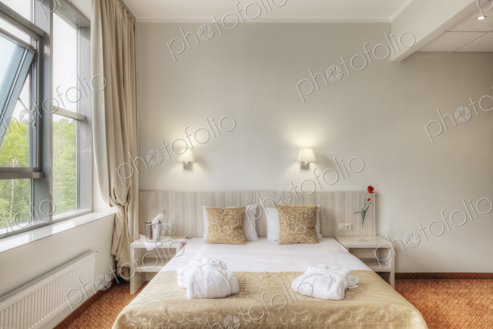 Folded robes on bed in hotel room