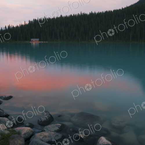 Forest treetops reflecting in still remote lake Forest treetops reflecting in still remote lake