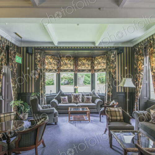 Formal hotel sitting room with ornate decoration.