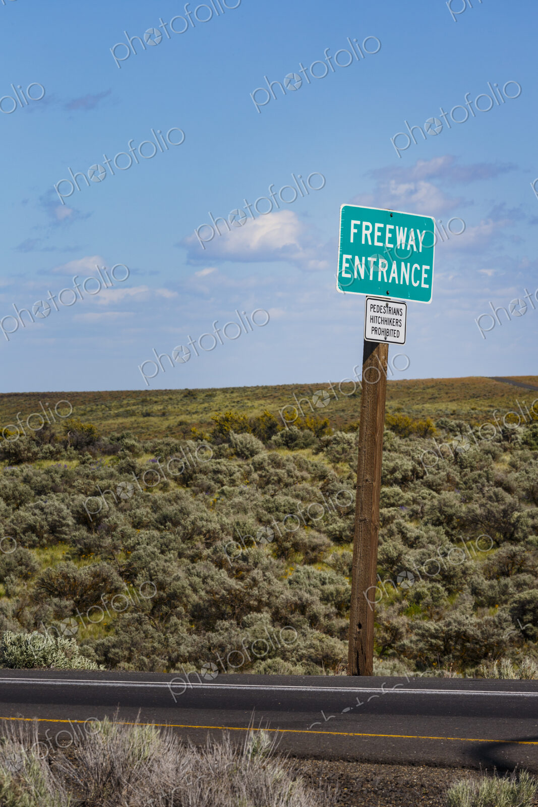 Freeway Entrance signs along the roadside in the rolling landscape of Kittikas county.