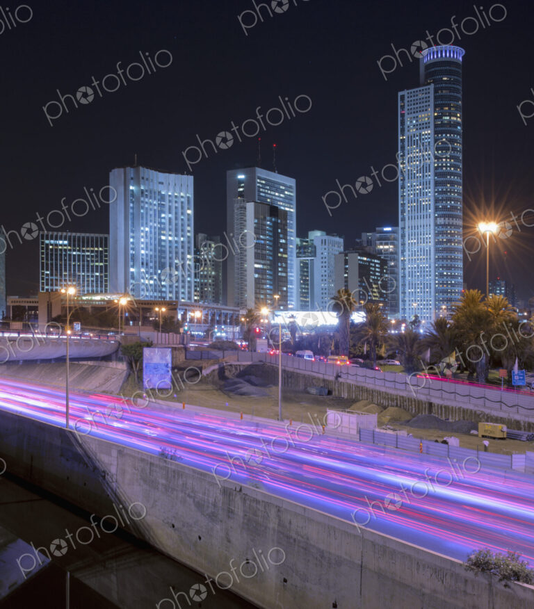 Freeway Passing Downtown Buildings At Night