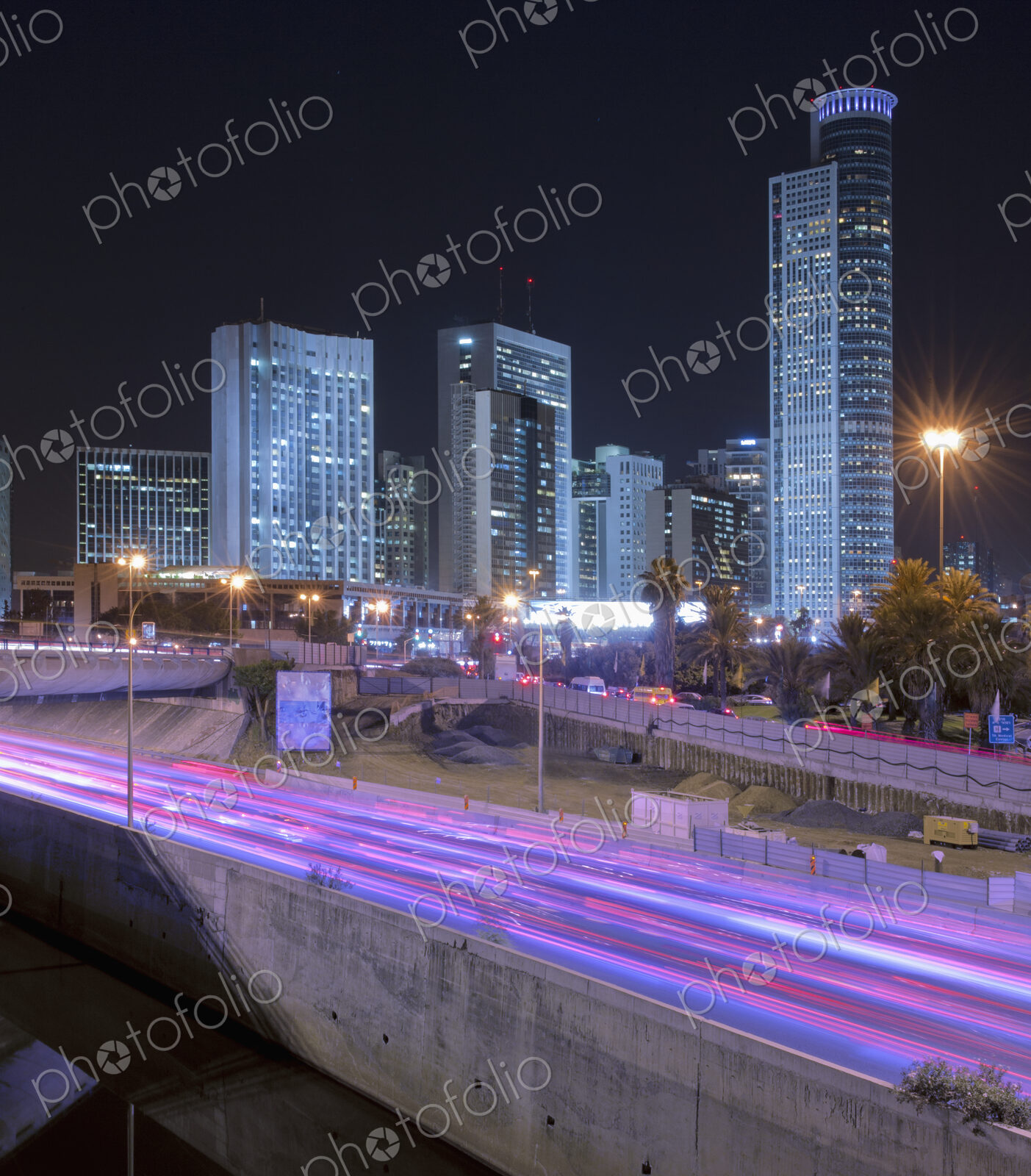 Freeway Passing Downtown Buildings At Night