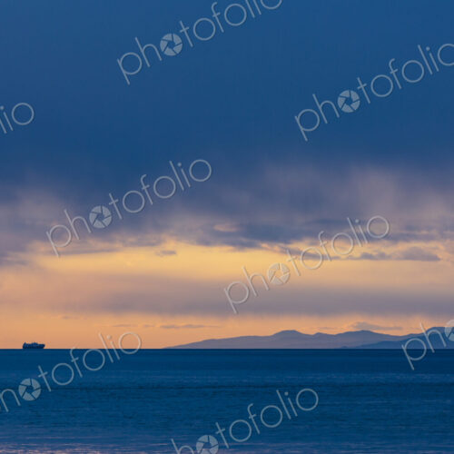 Freighter on horizon after a clearing storm, Strait of Juan de Fuca, WA USA