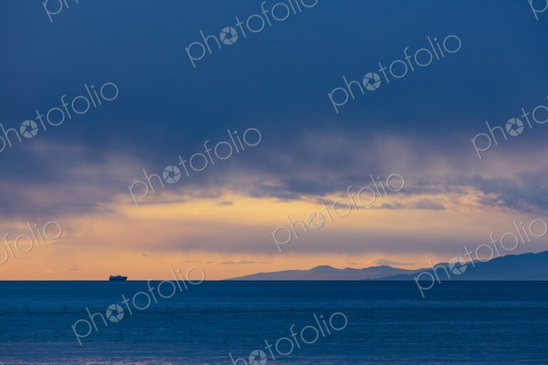 Freighter on horizon after a clearing storm, Strait of Juan de Fuca, WA USA