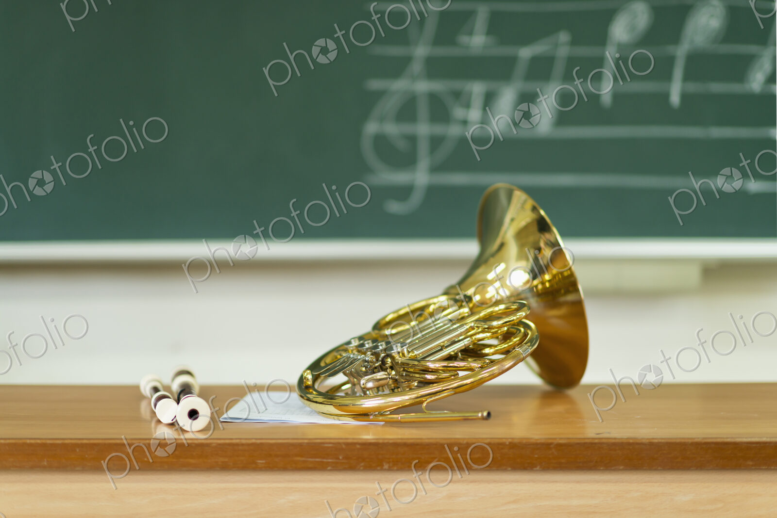French horn sitting on desk in classroom