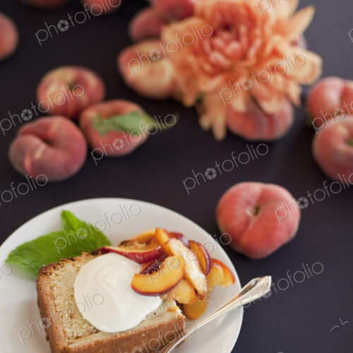 Fresh fruit and flowers. A slice of organic peach cake with a serving of creme fraiche…