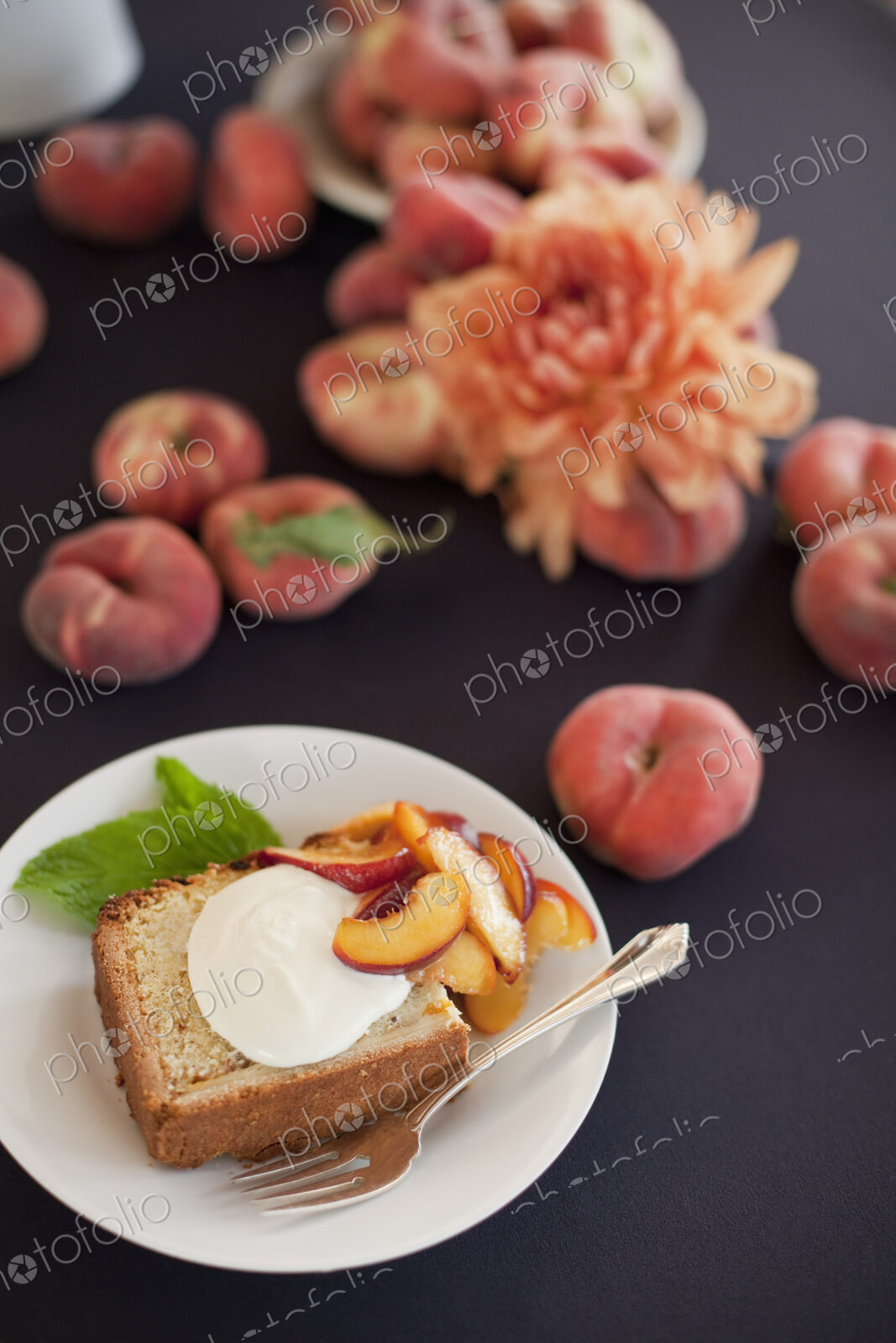 Fresh fruit and flowers. A slice of organic peach cake with a serving of creme fraiche…