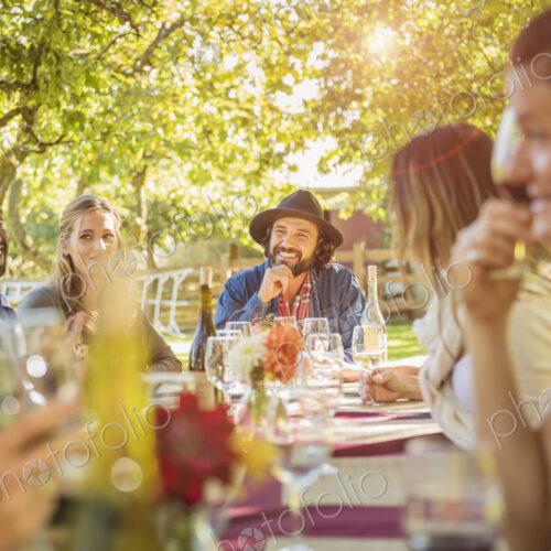 Friends drinking wine at party outdoors Friends drinking wine at party outdoors